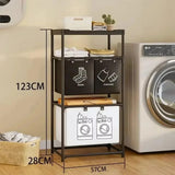 Black 3-tier laundry basket with storage rack beside a washing machine, showing dimensions of 123 cm height, 57 cm length and 28 cm width.
