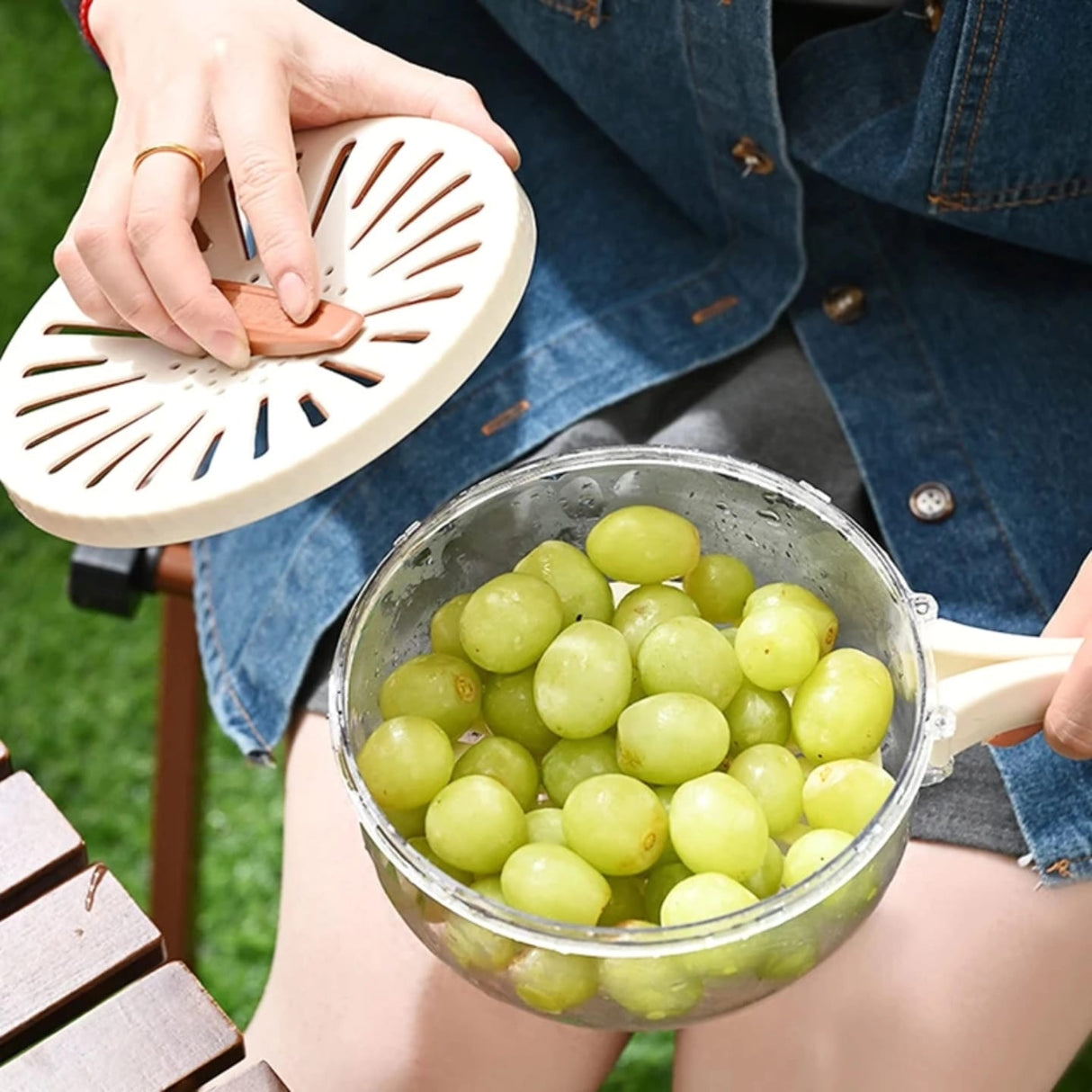 Multi-Functional Food Storage and Drainer Container with Foldable Handle and Drain Switch.