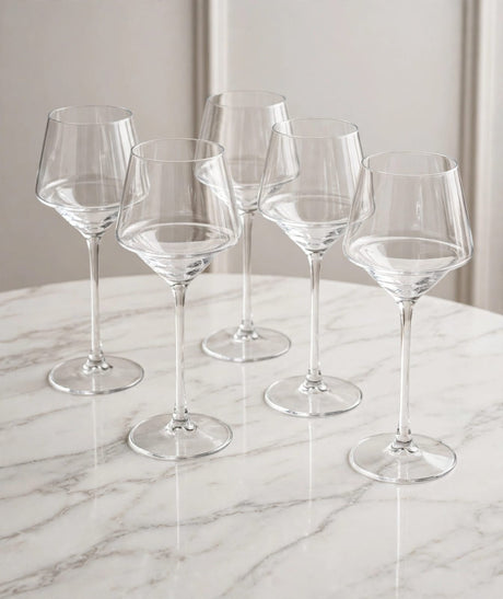 Stemmed wine glasses arranged on a table.