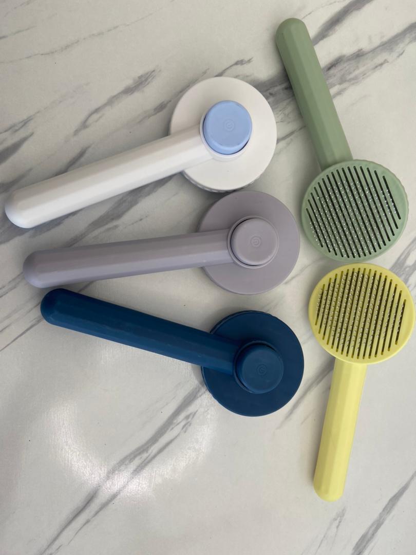Self Cleaning Pet Comb | Stainless Steel Grooming Brush. Available in White, Pink, Blue, Grey, Green, and Yellow