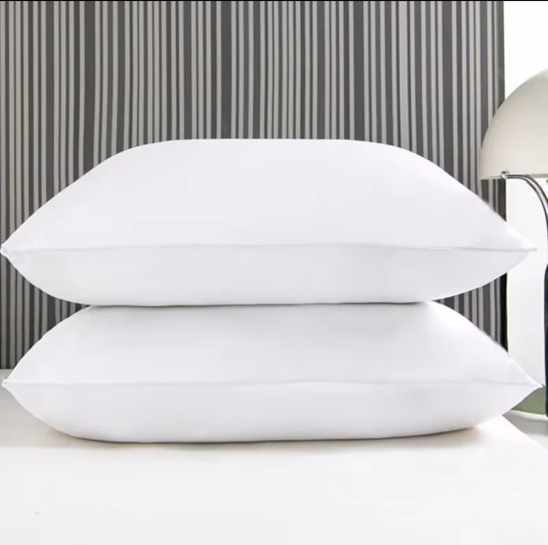 Furaha Finds Printed Hollow Bed Pillows with soft microfiber filling. Available in 1000gms and 750gsm pairs. White with stylish patterns for ultimate comfort.